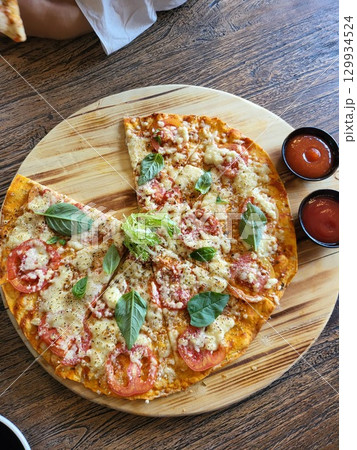 This is round of pizza on the table This is round of pizza on the table 129934524