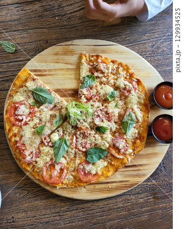 This is round of pizza on the table This is round of pizza on the table 129934525