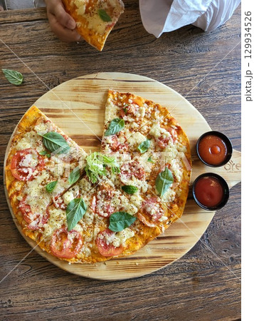 This is round of pizza on the table  129934526