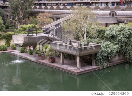 the Barbican Centre's unique multi-level water gardens, which seamlessly integrate concrete staircases and elevated planters within the landscape design, The plants and trees contribute to the 129934869