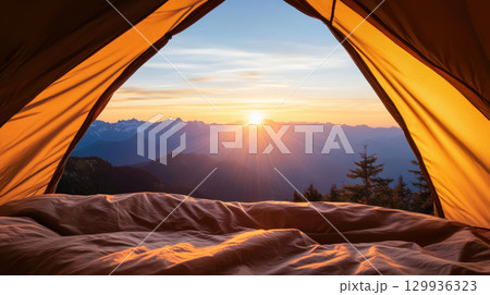 cozy tent interior with stunning sunrise view over mountains, creating serene atmosphere 129936323