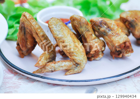 chicken wings or deep fried chicken , fried chicken and sauce 129940434