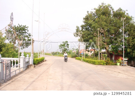 rural road in vietnam with people riding bicycles and motorbikes 129945281