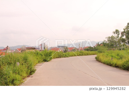 rural road in vietnam with people riding bicycles and motorbikes 129945282