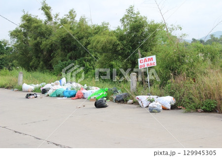 rural road in vietnam with people riding bicycles and motorbikes 129945305