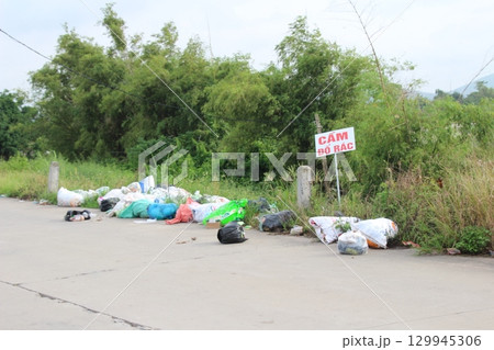 rural road in vietnam with people riding bicycles and motorbikes 129945306