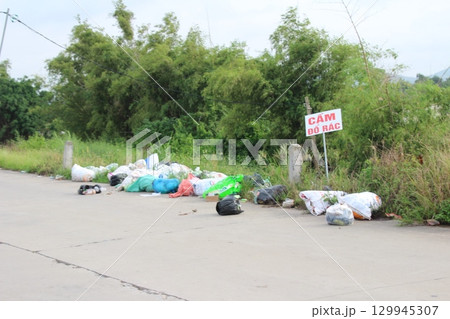 rural road in vietnam with people riding bicycles and motorbikes 129945307