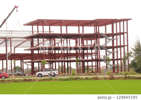 on construction site in vietnam. Construction workers. Machinery is digging the ground 129945595