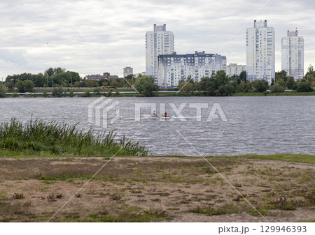 People practicing rowing on the lake. Sports People practicing rowing on the lake. Sports 129946393