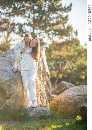 Young mother and cute little daughter playing together in autumn park in Prague, Europe 129946569