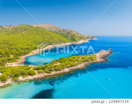 Drone view of a sea bay with turquoise transparent water. Boats and yachts.  129947114