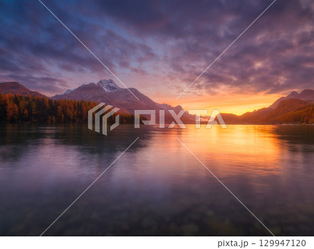 Nature. Mountain lake at dawn. Bright sky and clouds. Reflections on the water surface. 129947120