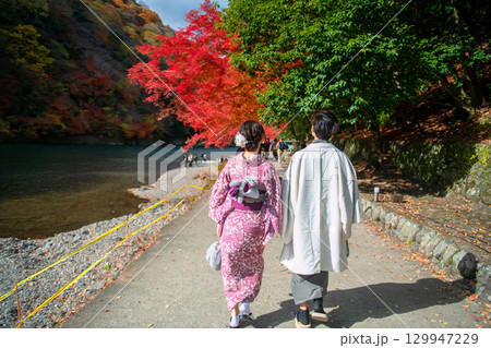 couple in kimono walk by river Arashiyama to view fall colors, Kyoto couple in kimono walk by river Arashiyama to view fall colors, Kyoto 129947229