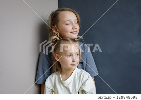Lovely young sister and brother hugging indoor. Sibling children together portrait 129948698