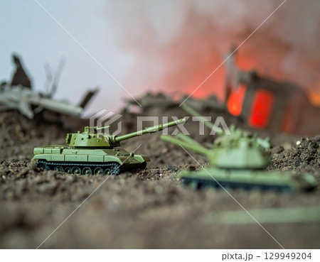 Miniature Tanks in a War Scene, dominate a scene of simulated conflict 129949204