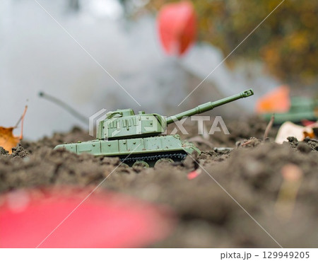 Miniature Tank in a War Scene, dominate a scene of simulated conflict Miniature Tank in a War Scene, dominate a scene of simulated conflict 129949205
