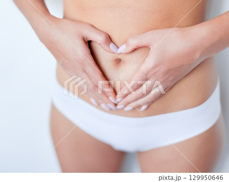 Female caucasian adult wellness gesture on stomach in white underwear 129950646