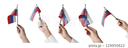 The Slovakia flag in hand in different angles on a white background 129950822