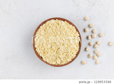 Lupines flour in a wooden bowl on a gray background. Gluten-free, protein-rich food. Top view. Lupines flour in a wooden bowl on a gray background. Gluten-free, protein-rich food. Top view. 129953588