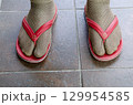 Funny fashion fail with socks and flip flops on tiles 129954585