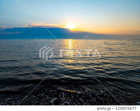Aerial view sunset sky,Nature beautiful Light Sunset or sunrise over sea,Colorful dramatic sunset Sky, Amazing clouds and waves in sunrise sky golden light cloud background Aerial view sunset sky,Nature beautiful Light Sunset or sunrise over sea,Colorful dramatic sunset Sky, Amazing clouds and waves in sunrise sky golden light cloud background 129955677