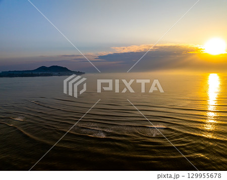 Aerial view sunset sky,Nature beautiful Light Sunset or sunrise over sea,Colorful dramatic sunset Sky, Amazing clouds and waves in sunrise sky golden light cloud background 129955678