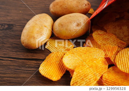 Potato chips , delicious BBQ seasoning spicy for crips, thin slice deep fried snack fast food. 129956328