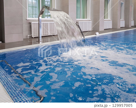 Whirlpool installation in an indoor pool, close-up, for relaxing and massaging the neck and back 129957005
