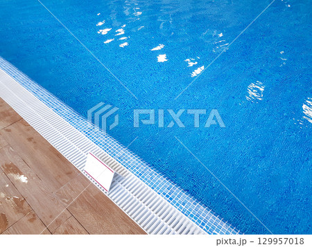 Borderline floor to pool with clear refreshing blue water in the modern resort spa area of the hotel Borderline floor to pool with clear refreshing blue water in the modern resort spa area of the hotel 129957018