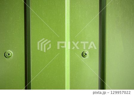 Green industrial background self-drilling in corrugated sheet close-up Green industrial background self-drilling in corrugated sheet close-up 129957022