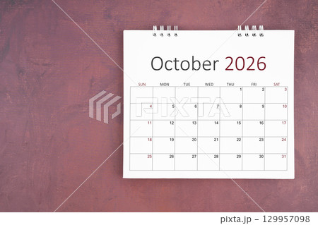 October 2026 desk calendar on red cement wall background. Page of annual monthly calendar for plan. 129957098