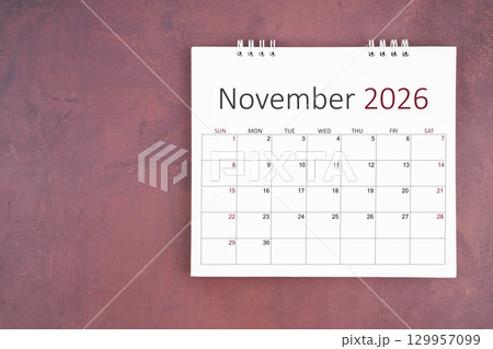 November 2026 desk calendar on red cement wall background. Page of annual monthly calendar for plan. November 2026 desk calendar on red cement wall background. Page of annual monthly calendar for plan. 129957099