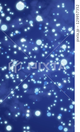 Soft glowing blue bokeh lights scattered across a deep blue background, creating a dreamy night atmosphere Soft glowing blue bokeh lights scattered across a deep blue background, creating a dreamy night atmosphere 129957352