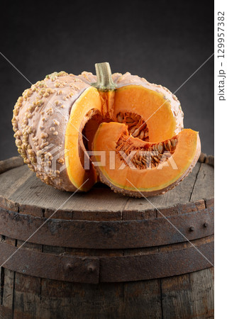Cut Musquee de Maroc Pumpkin on Wooden Barrel Cut Musquee de Maroc Pumpkin on Wooden Barrel 129957382