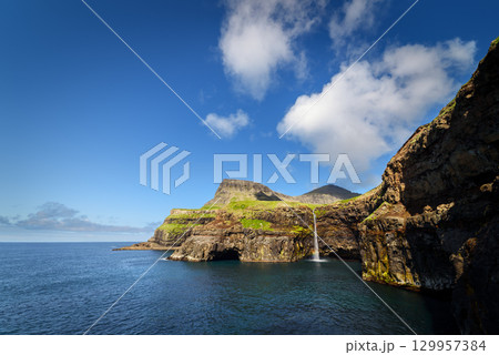 Mulafossur Waterfall Flowing into the Ocean in Vagar Faroe Islands Mulafossur Waterfall Flowing into the Ocean in Vagar Faroe Islands 129957384