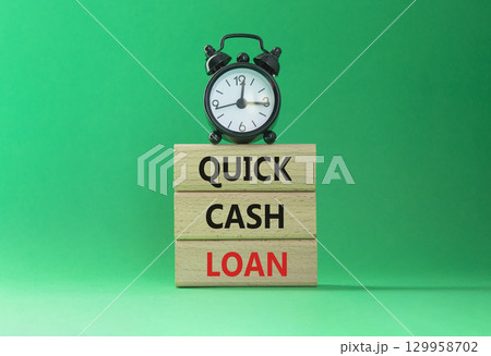 Quick Cash Loan symbol. Concept words Quick Cash Loan on wooden blocks. Beautiful green background with alarm clock. Business and Quick Cash Loan concept. Copy space. Quick Cash Loan symbol. Concept words Quick Cash Loan on wooden blocks. Beautiful green background with alarm clock. Business and Quick Cash Loan concept. Copy space. 129958702