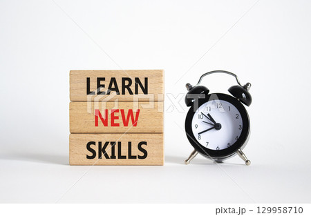 Learn new skills symbol. Concept words Learn new skills on wooden blocks. Beautiful white background with alarm clock. Business and Learn new skills concept. Copy space. Learn new skills symbol. Concept words Learn new skills on wooden blocks. Beautiful white background with alarm clock. Business and Learn new skills concept. Copy space. 129958710