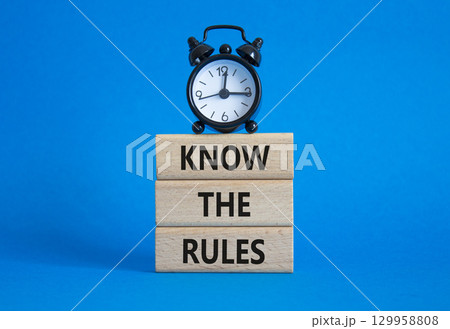 Know the rules symbol. Wooden blocks with words Know the rules. Beautiful blue background with alarm clock. Business and Know the rules concept. Copy space. Know the rules symbol. Wooden blocks with words Know the rules. Beautiful blue background with alarm clock. Business and Know the rules concept. Copy space. 129958808