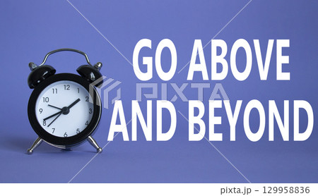 Go above and beyond symbol. Beautiful purple background with alarm clock. Business and Go above and beyond concept. Copy space. Go above and beyond symbol. Beautiful purple background with alarm clock. Business and Go above and beyond concept. Copy space. 129958836