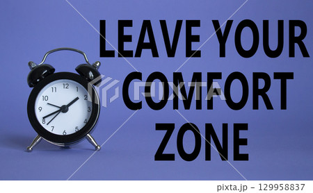 Leave your Comfort Zone symbol. Beautiful purple background with alarm clock. Business and Leave your Comfort Zone concept. Copy space. Leave your Comfort Zone symbol. Beautiful purple background with alarm clock. Business and Leave your Comfort Zone concept. Copy space. 129958837
