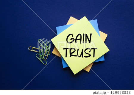 Gain trust symbol. Gain trust on sticky note. Beautiful deep blue background. Business and Gain trust concept. Copy space. Gain trust symbol. Gain trust on sticky note. Beautiful deep blue background. Business and Gain trust concept. Copy space. 129958838