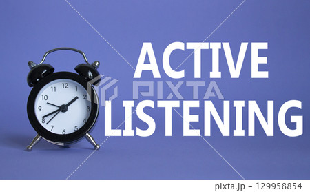 Active listening symbol. Beautiful purple background with alarm clock. Business and Active listening concept. Copy space. Active listening symbol. Beautiful purple background with alarm clock. Business and Active listening concept. Copy space. 129958854
