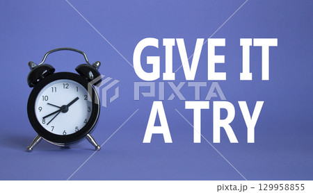 Give it a try symbol. Beautiful purple background with alarm clock. Business and Give it a try concept. Copy space. Give it a try symbol. Beautiful purple background with alarm clock. Business and Give it a try concept. Copy space. 129958855