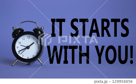 It starts with you symbol. Beautiful purple background with alarm clock. Business and It starts with you concept. Copy space. It starts with you symbol. Beautiful purple background with alarm clock. Business and It starts with you concept. Copy space. 129958856