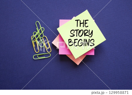 The Story Begins symbol. Sticky notes with words The Story Begins. Beautiful deep blue background. Business and The Story Begins concept. Copy space. The Story Begins symbol. Sticky notes with words The Story Begins. Beautiful deep blue background. Business and The Story Begins concept. Copy space. 129958871