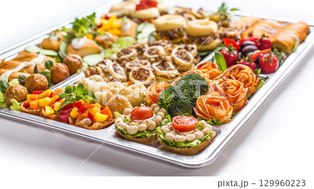 Assorted appetizer platter vibrantly displayed. Assorted appetizer platter vibrantly displayed. 129960223