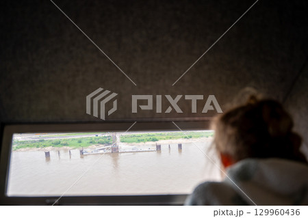 silhouette Young girl looking out the observation window at Gateway National Park St. Louis Arch silhouette Young girl looking out the observation window at Gateway National Park St. Louis Arch 129960436