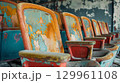 Weathered stadium seats with peeling paint 129961108
