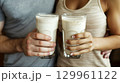 Couple holding glasses of milk 129961122