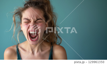 Woman yelling with intense expression. 129961350